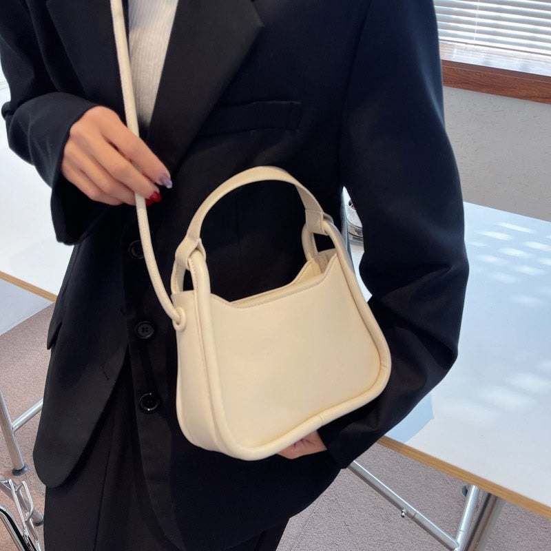 Sleek Black Leather Shoulder Bag with Curved Base