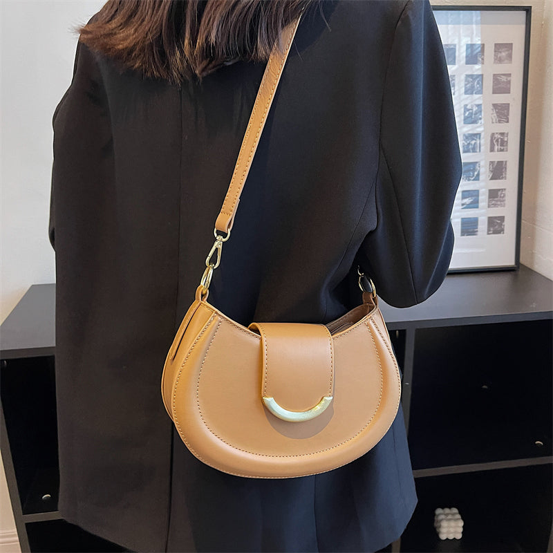 Black Leather Shoulder Bag with Gold Hardware and Flap Closure