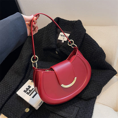 Black Leather Shoulder Bag with Gold Hardware and Flap Closure