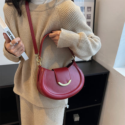 Black Leather Shoulder Bag with Gold Hardware and Flap Closure