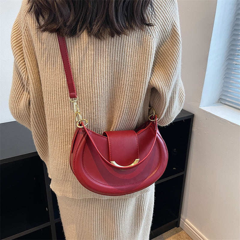 Black Leather Shoulder Bag with Gold Hardware and Flap Closure