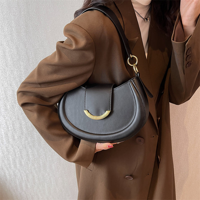 Black Leather Shoulder Bag with Gold Hardware and Flap Closure