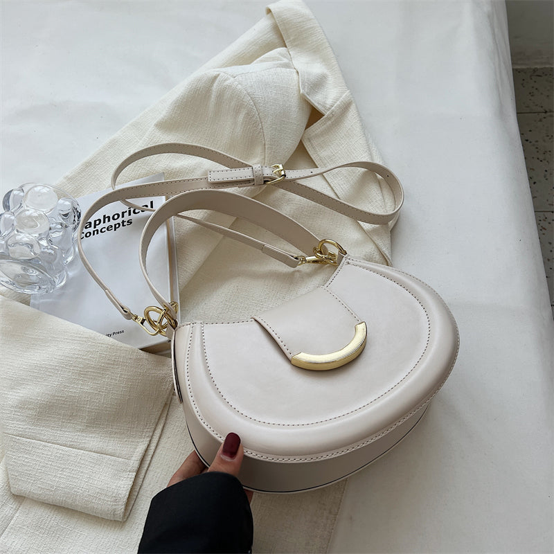 Black Leather Shoulder Bag with Gold Hardware and Flap Closure