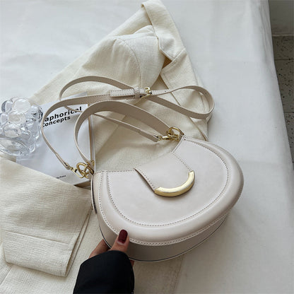Black Leather Shoulder Bag with Gold Hardware and Flap Closure