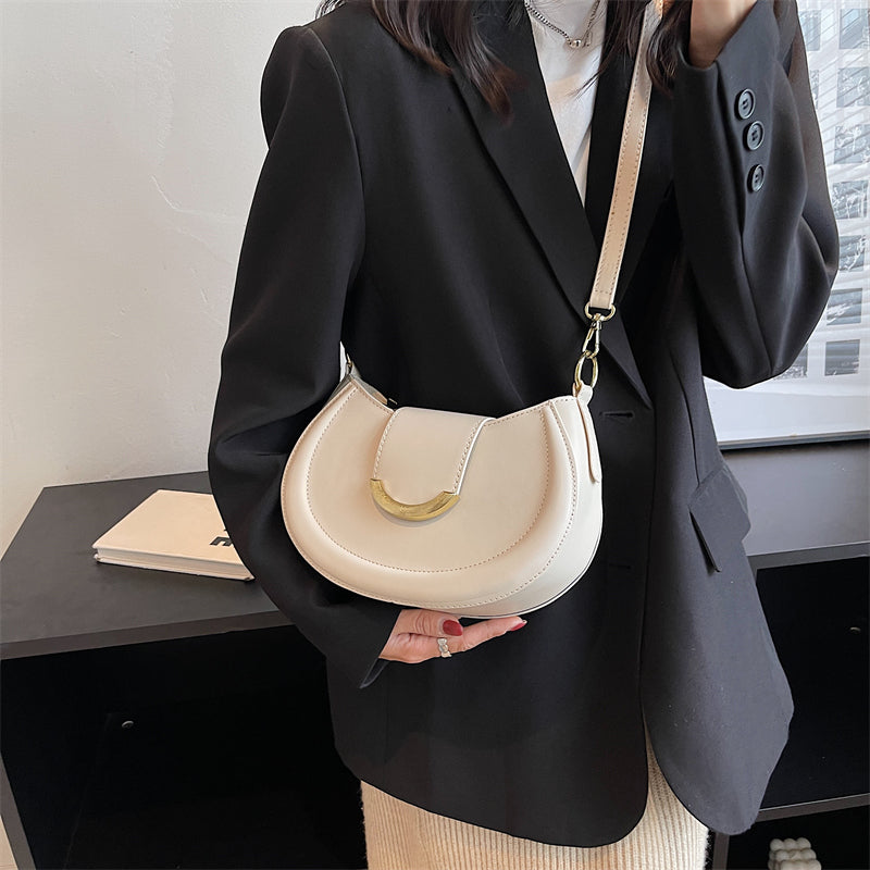 Black Leather Shoulder Bag with Gold Hardware and Flap Closure