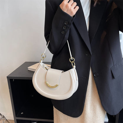 Black Leather Shoulder Bag with Gold Hardware and Flap Closure