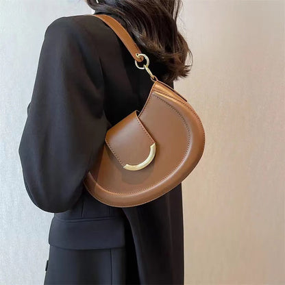 Black Leather Shoulder Bag with Gold Hardware and Flap Closure