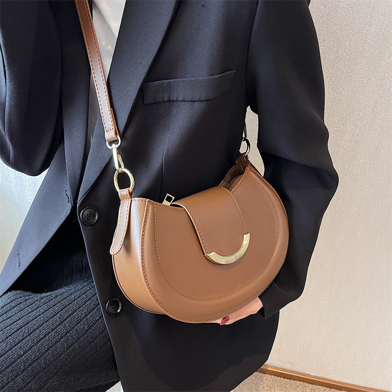 Black Leather Shoulder Bag with Gold Hardware and Flap Closure
