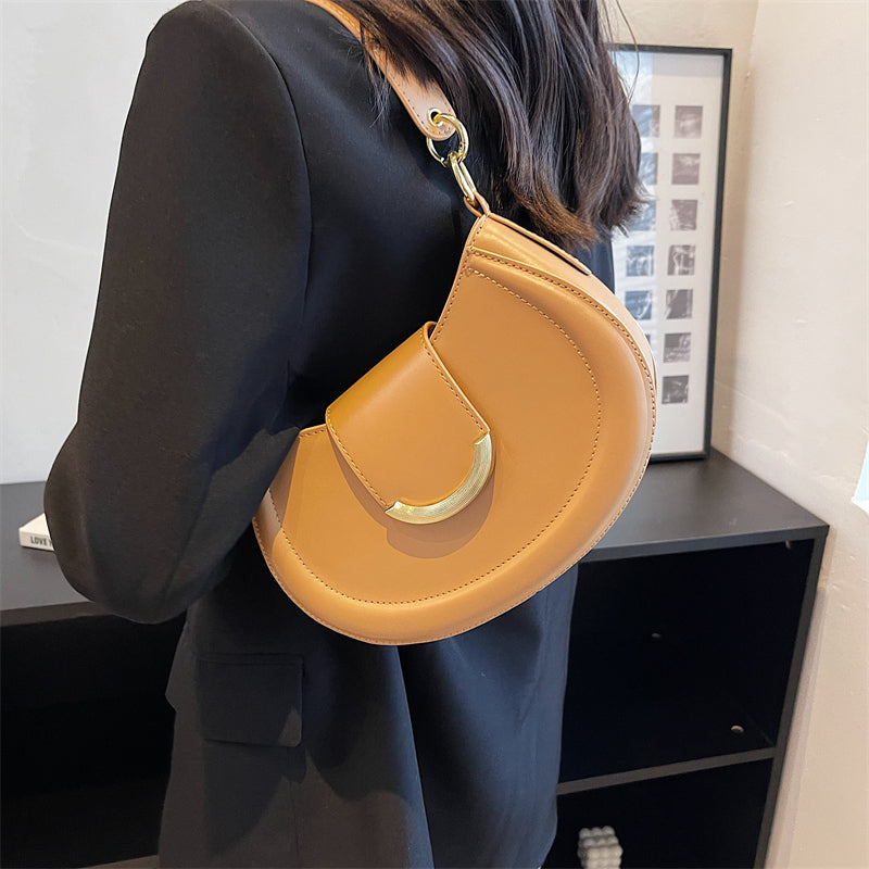Black Leather Shoulder Bag with Gold Hardware and Flap Closure