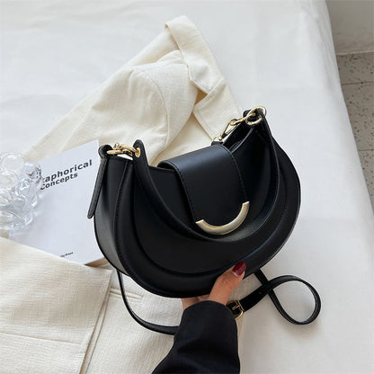 Black Leather Shoulder Bag with Gold Hardware and Flap Closure