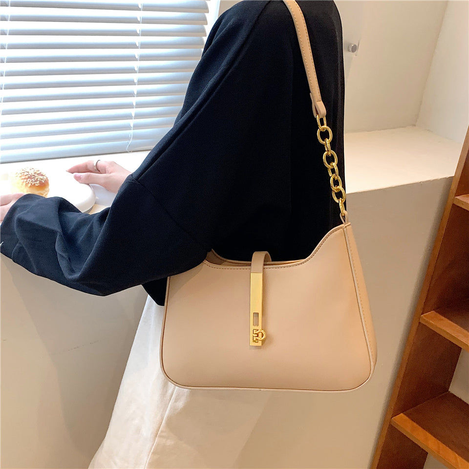 Chic Leather Shoulder Bag with Gold Chain and Bar Closure