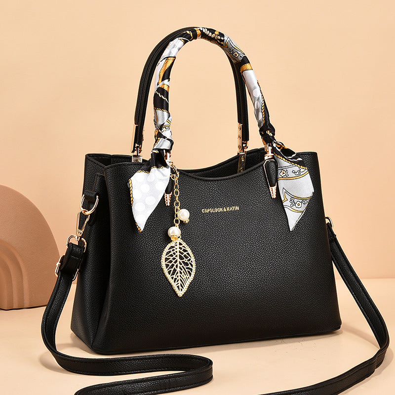 Leather Shoulder Bag with Scarf-Wrapped Handles and Gold Leaf Charm