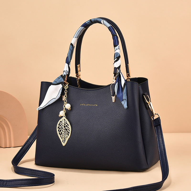 Leather Shoulder Bag with Scarf-Wrapped Handles and Gold Leaf Charm