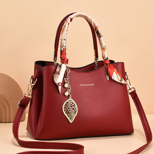 Leather Shoulder Bag with Scarf-Wrapped Handles and Gold Leaf Charm