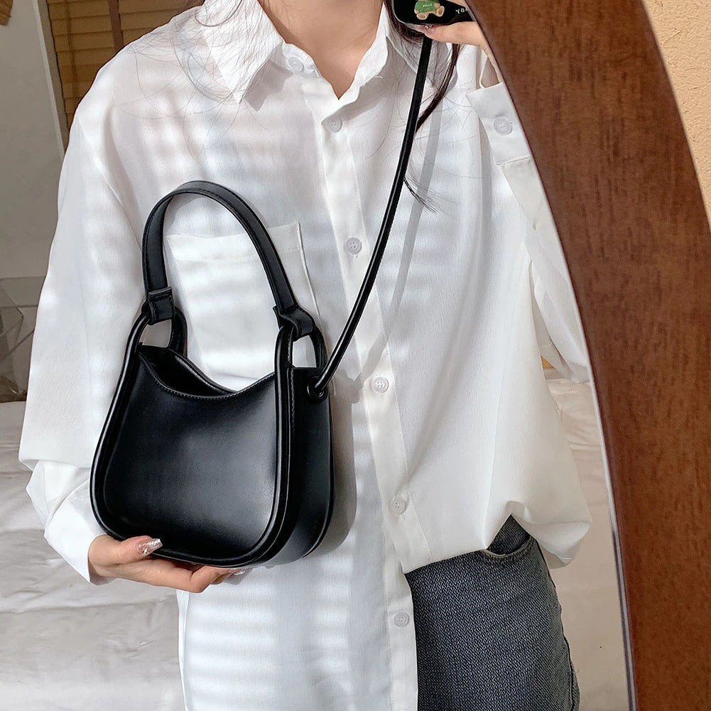 Sleek Black Leather Shoulder Bag with Curved Base