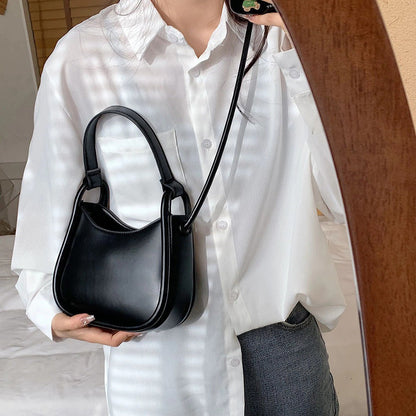 Sleek Black Leather Shoulder Bag with Curved Base