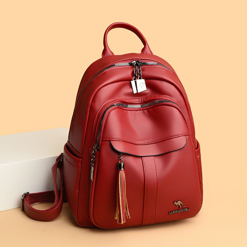 Sleek Leather Backpack with Tassel Detail and Silver Hardware