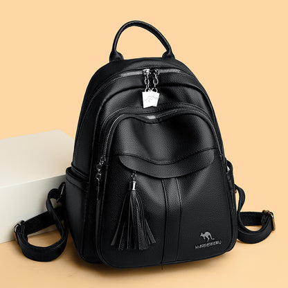 Sleek Leather Backpack with Tassel Detail and Silver Hardware