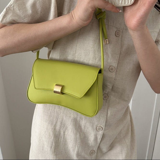 Sleek Leather Shoulder Bag with Gold Clasp and Knot Strap