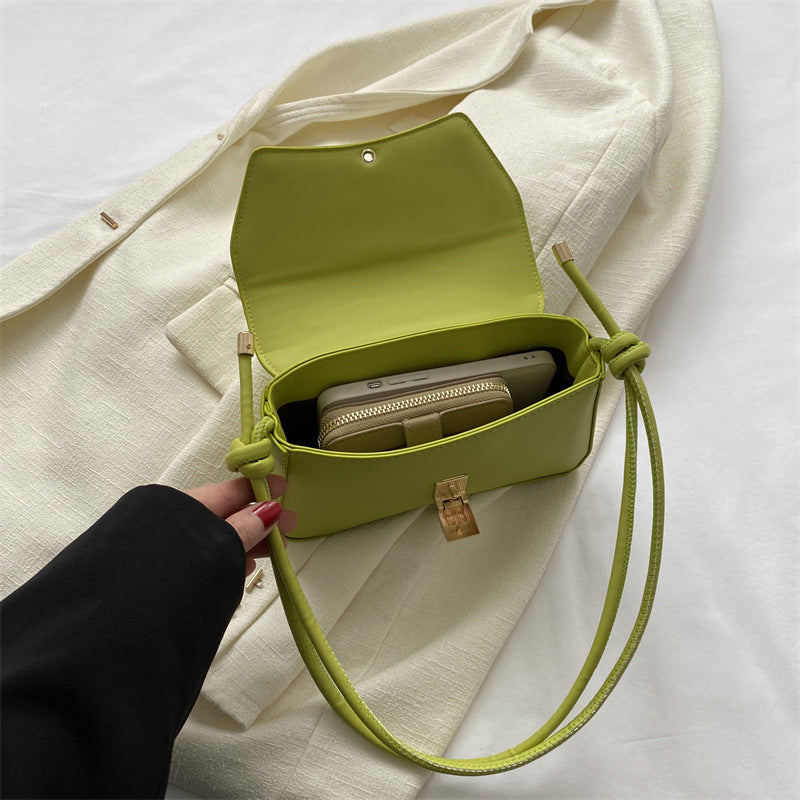 Sleek Leather Shoulder Bag with Gold Clasp and Knot Strap