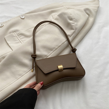 Sleek Leather Shoulder Bag with Gold Clasp and Knot Strap