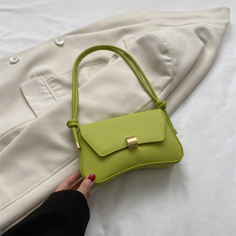 Sleek Leather Shoulder Bag with Gold Clasp and Knot Strap