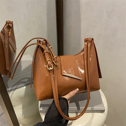 Sleek Leather Shoulder Bag with Gold Hardware and Front Pocket