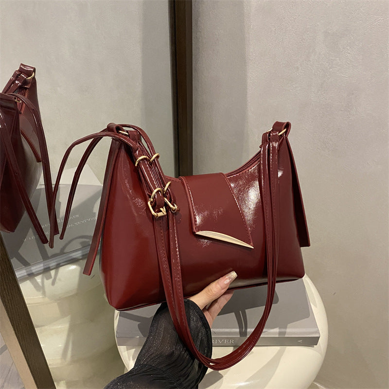 Sleek Leather Shoulder Bag with Gold Hardware and Front Pocket
