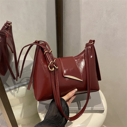 Sleek Leather Shoulder Bag with Gold Hardware and Front Pocket