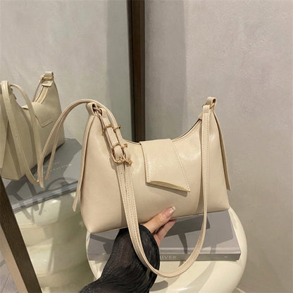 Sleek Leather Shoulder Bag with Gold Hardware and Front Pocket