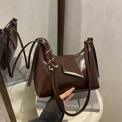 Sleek Leather Shoulder Bag with Gold Hardware and Front Pocket